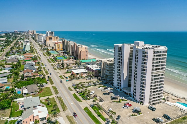 drone / aerial view featuring a water view and a beach view