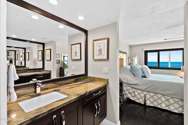 bathroom featuring vanity, a water view, and wood-type flooring