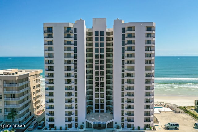 view of property with a view of the beach and a water view