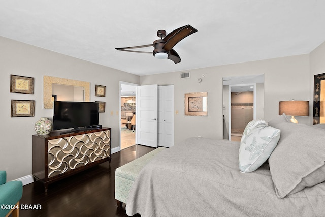 bedroom with dark wood-type flooring, a closet, and ceiling fan