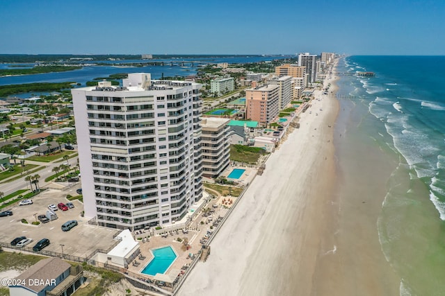 bird's eye view with a water view and a beach view