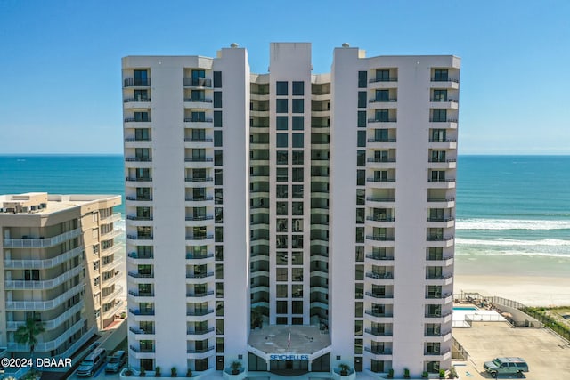 view of property featuring a water view and a beach view