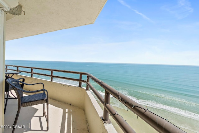 balcony with a view of the beach and a water view