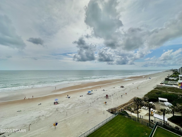 water view featuring local beach and fence