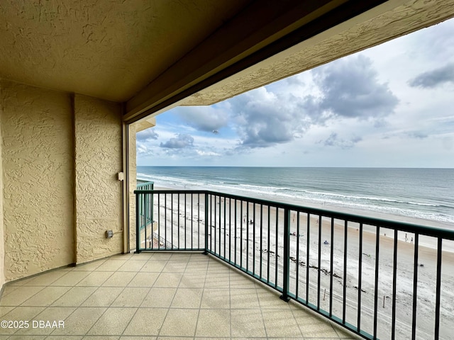 balcony featuring view of water and beach