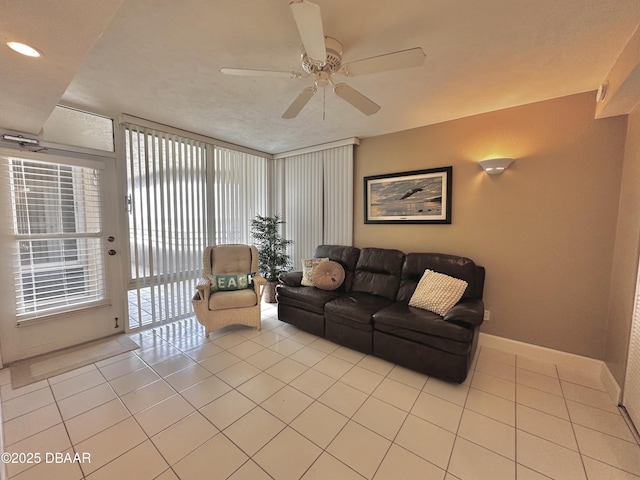 living room with light tile patterned flooring, a ceiling fan, baseboards, and recessed lighting