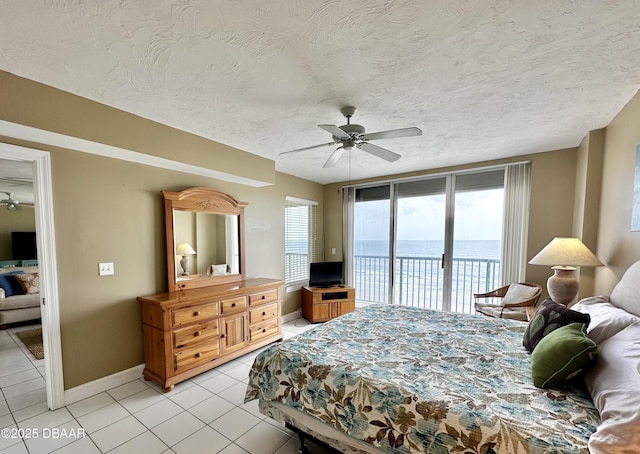 bedroom featuring access to outside, light tile patterned flooring, baseboards, ceiling fan, and a textured ceiling