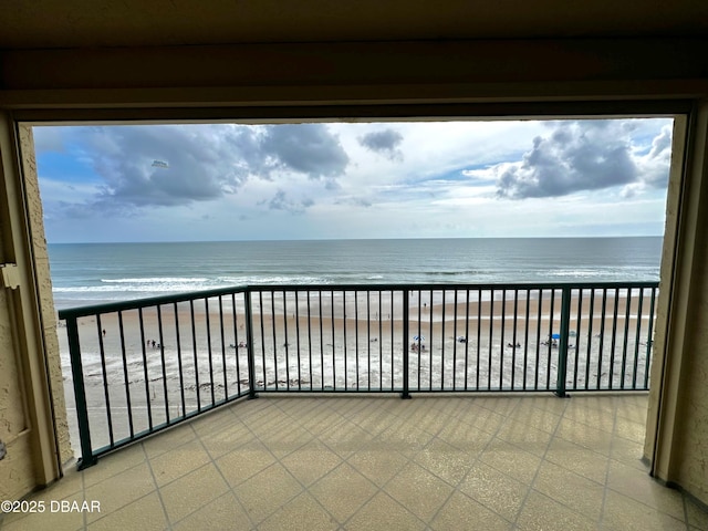 balcony with view of water and beach