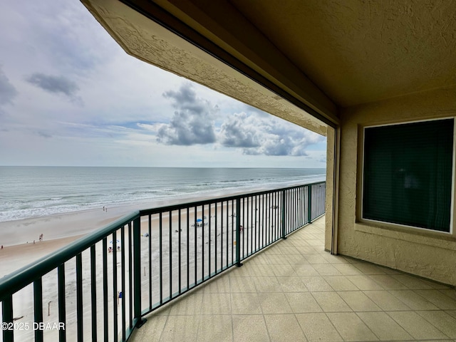 balcony featuring view of water and beach
