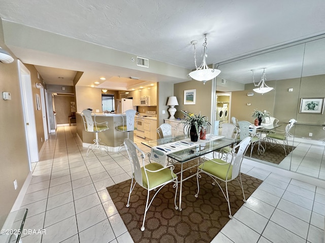 dining area with light tile patterned floors and baseboards