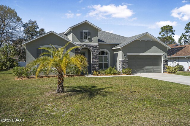 view of front of property featuring a garage, concrete driveway, stone siding, stucco siding, and a front lawn