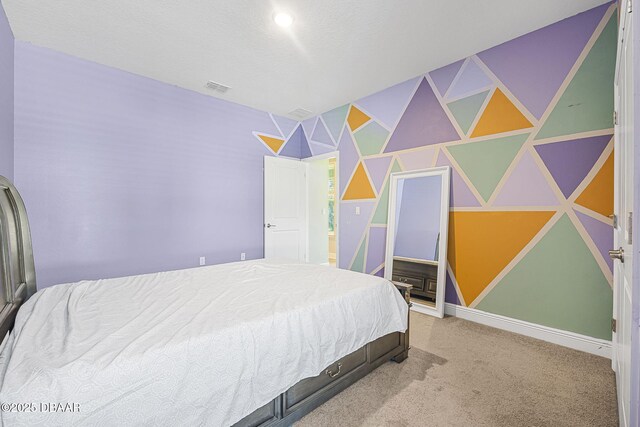 carpeted bedroom featuring baseboards and visible vents