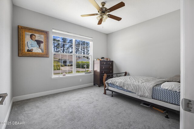 carpeted bedroom featuring a ceiling fan and baseboards