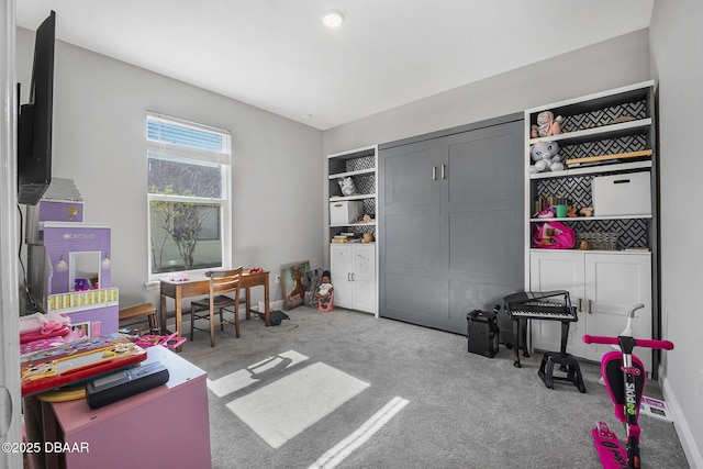 rec room with carpet and baseboards