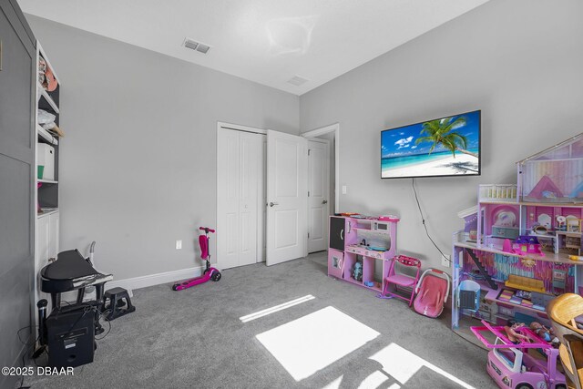 game room with carpet flooring, visible vents, and baseboards