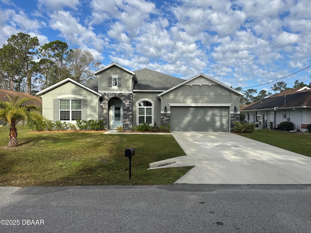 view of front of house with a garage and a front yard