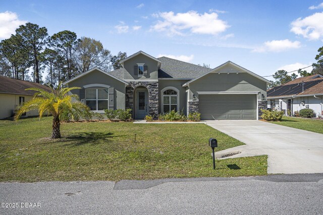 view of front facade featuring stone siding, a front yard, concrete driveway, and an attached garage