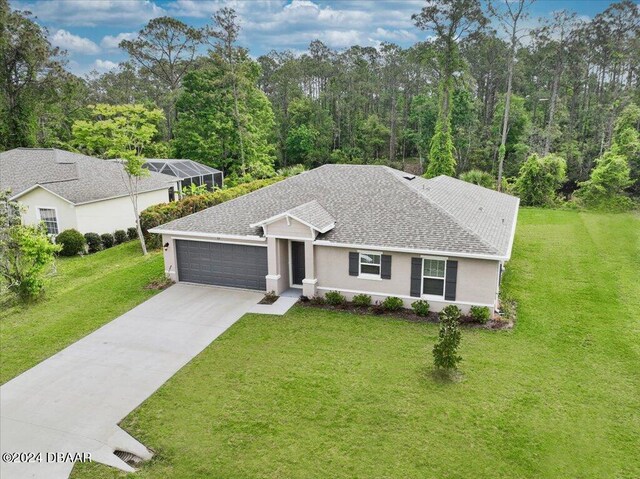 view of front facade with a front lawn and a garage