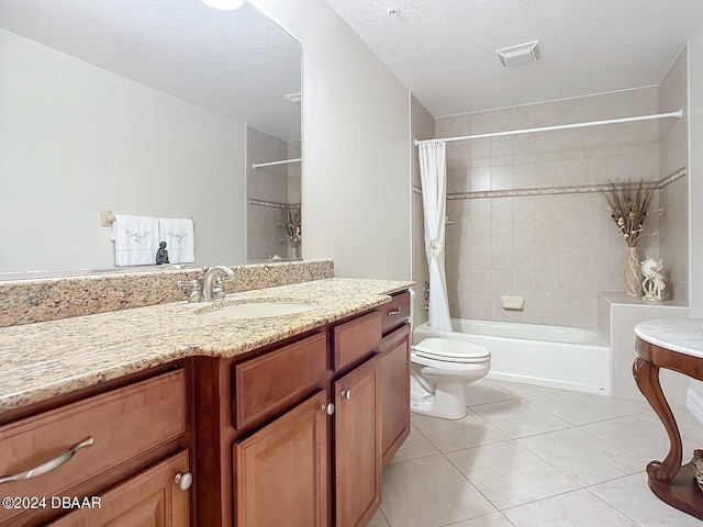 full bath with toilet, shower / tub combo, vanity, a textured ceiling, and tile patterned floors