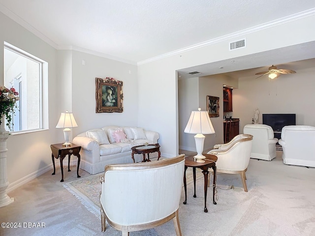 carpeted living room featuring ceiling fan and ornamental molding