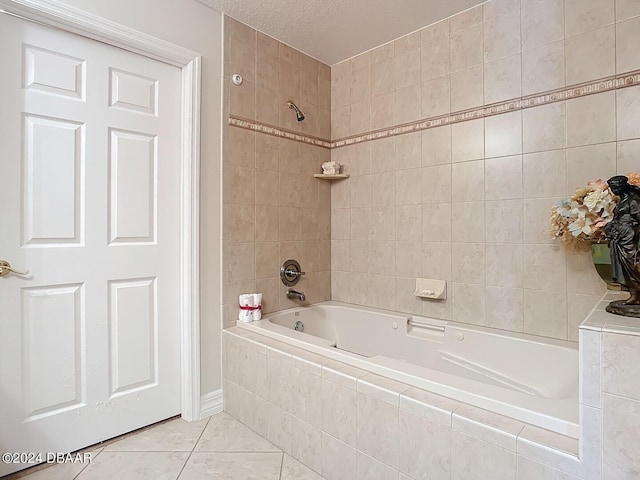 full bathroom with tiled shower / bath combo, a textured ceiling, and tile patterned floors