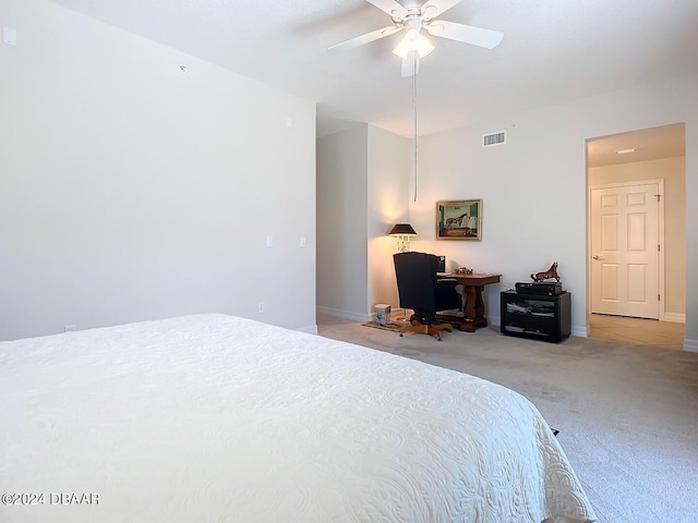 bedroom with light carpet, ceiling fan, visible vents, and baseboards