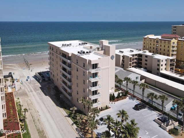 aerial view with a water view and a view of the beach