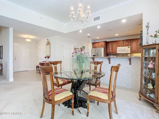 carpeted dining space featuring an inviting chandelier and ornamental molding