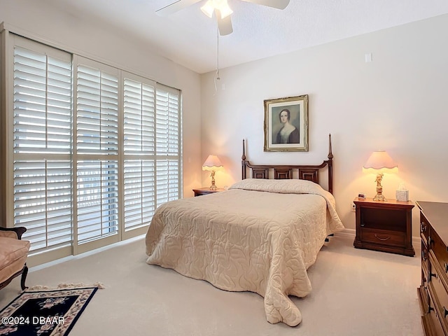 carpeted bedroom with a ceiling fan and baseboards