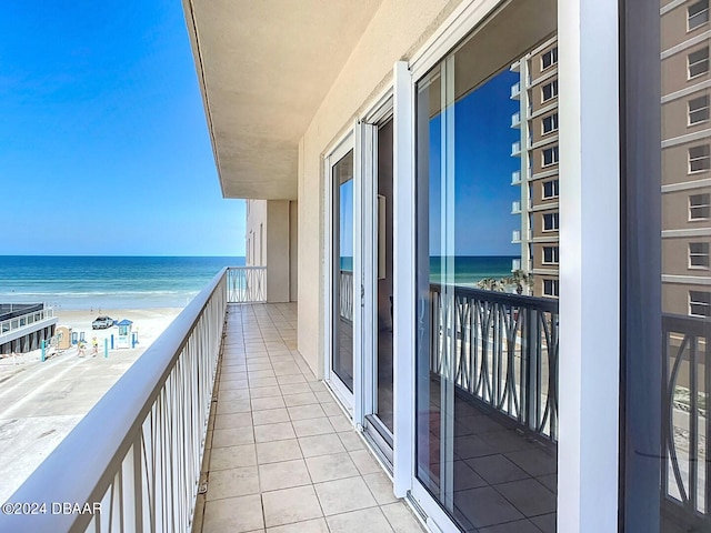 balcony with a beach view and a water view