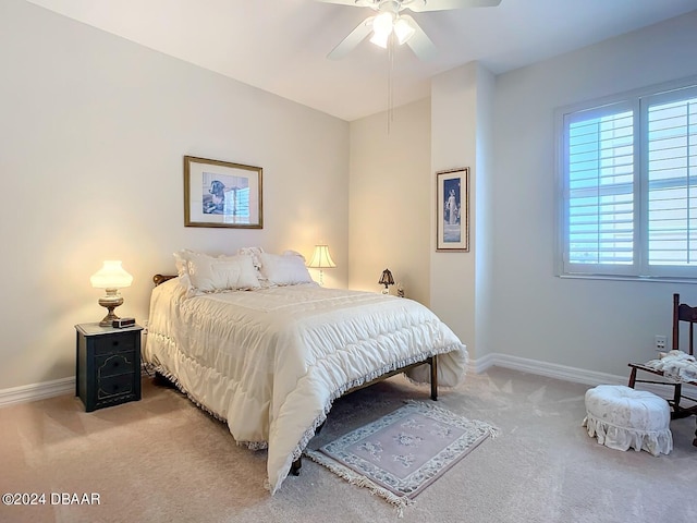 bedroom featuring baseboards, ceiling fan, and light colored carpet