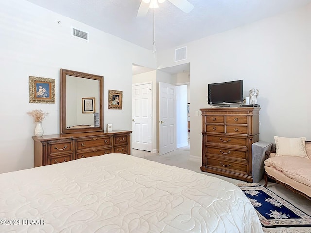 bedroom with a ceiling fan, visible vents, and light colored carpet