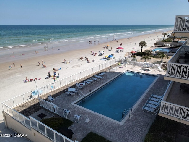 bird's eye view with a water view and a beach view