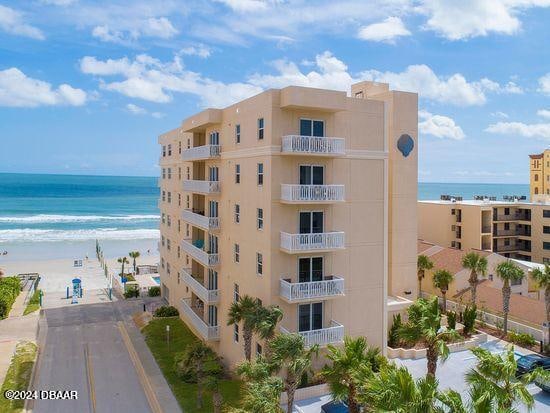 view of property featuring a water view and a view of the beach