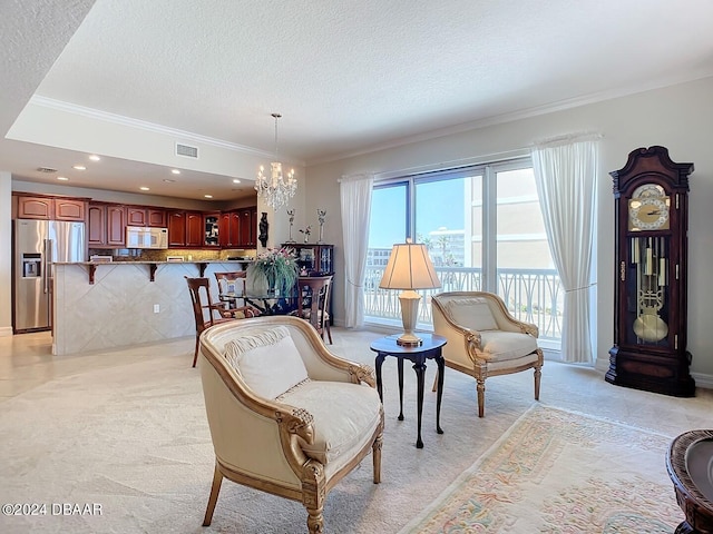 sitting room with light colored carpet, ornamental molding, a textured ceiling, and a notable chandelier