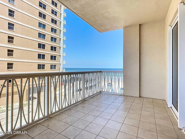 balcony featuring a water view and a view of the beach