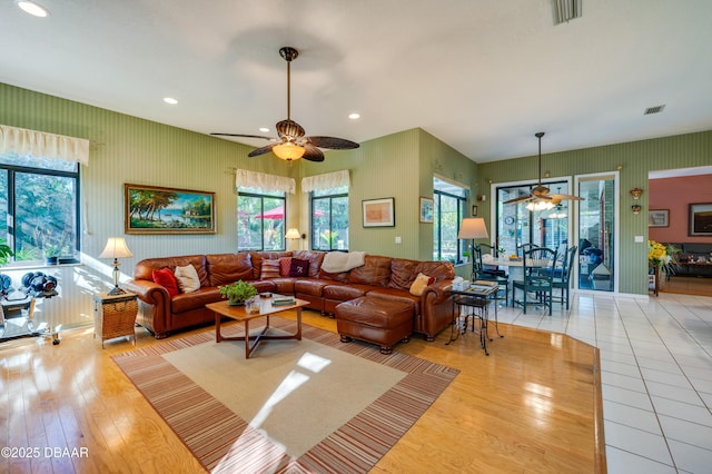 living room featuring a wealth of natural light, hardwood / wood-style floors, and ceiling fan