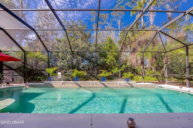 view of swimming pool featuring glass enclosure