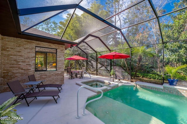 view of swimming pool featuring an in ground hot tub, glass enclosure, and a patio