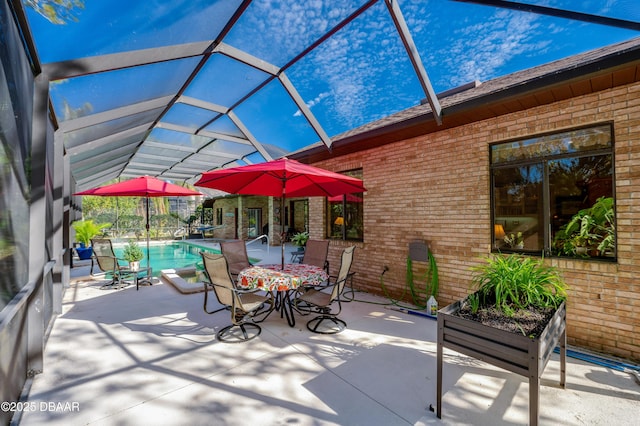 view of patio / terrace featuring glass enclosure