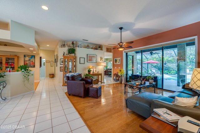 living room with ceiling fan and light wood-type flooring