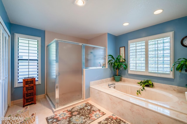 bathroom with tile patterned flooring and separate shower and tub