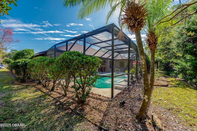 view of swimming pool featuring a lanai