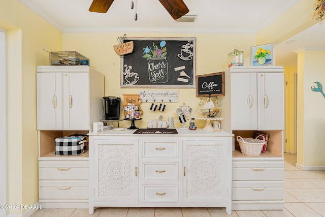 bar featuring white cabinets, light tile patterned flooring, crown molding, and ceiling fan