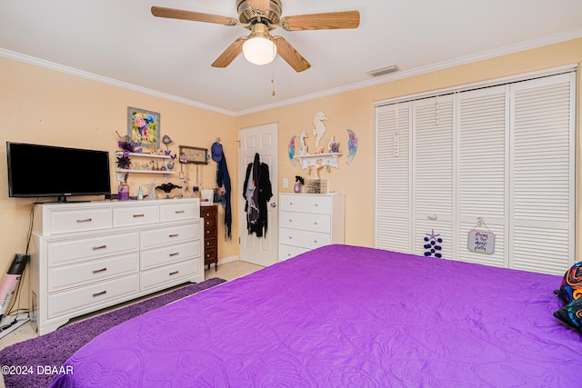 carpeted bedroom with ceiling fan, a closet, and ornamental molding