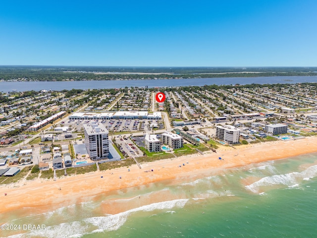 aerial view with a water view and a beach view