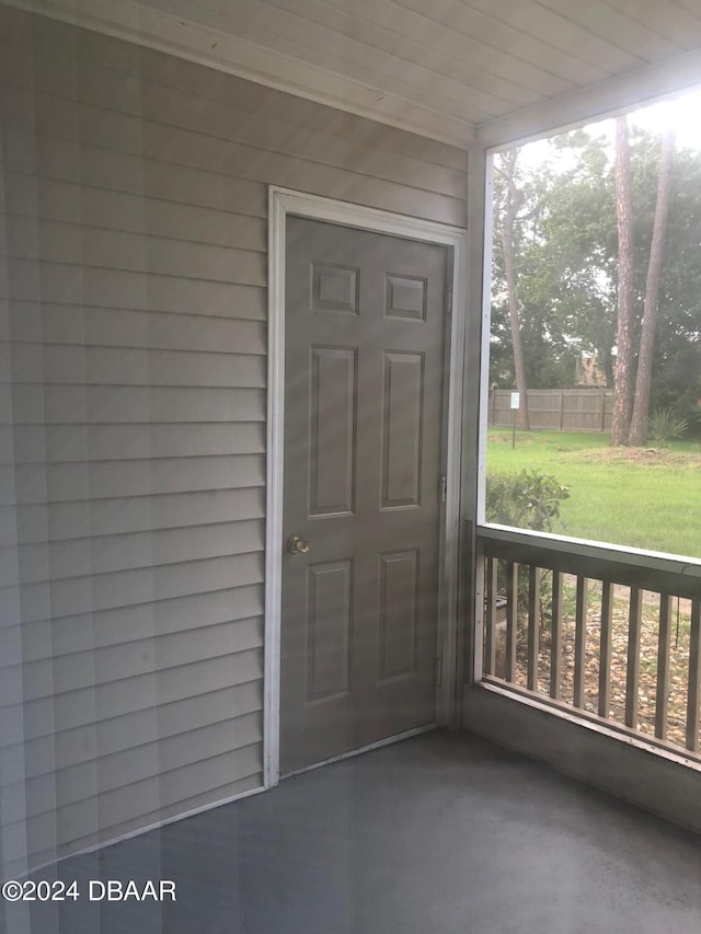 view of exterior entry featuring a yard