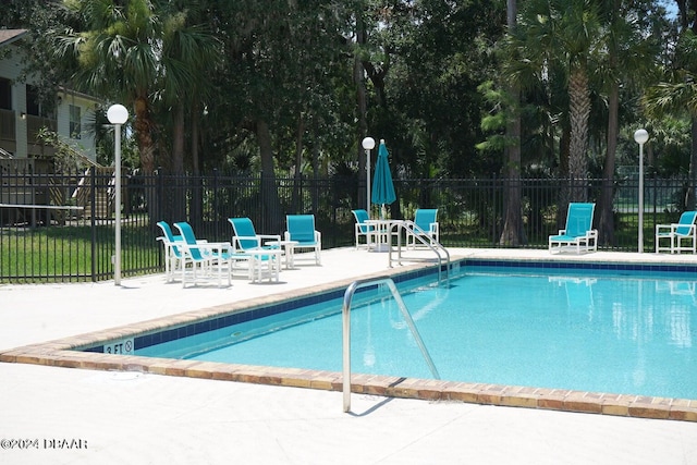 view of swimming pool featuring a patio area