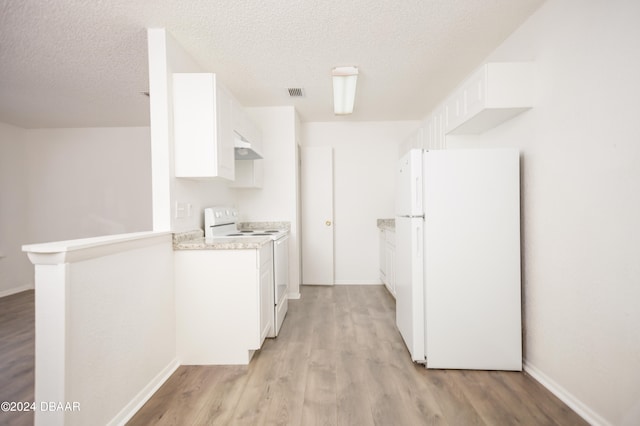 kitchen with white appliances, a textured ceiling, light hardwood / wood-style floors, and white cabinets