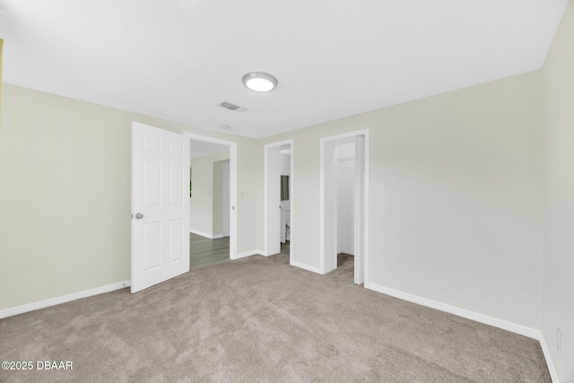 carpeted spare room featuring baseboards